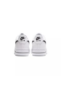 Le sneaker Nike Air bianche presentano una tomaia in pelle liscia, dettagli neri, una suola spessa e un colletto imbottito per il supporto. Il logo è ben visibile sul tallone.