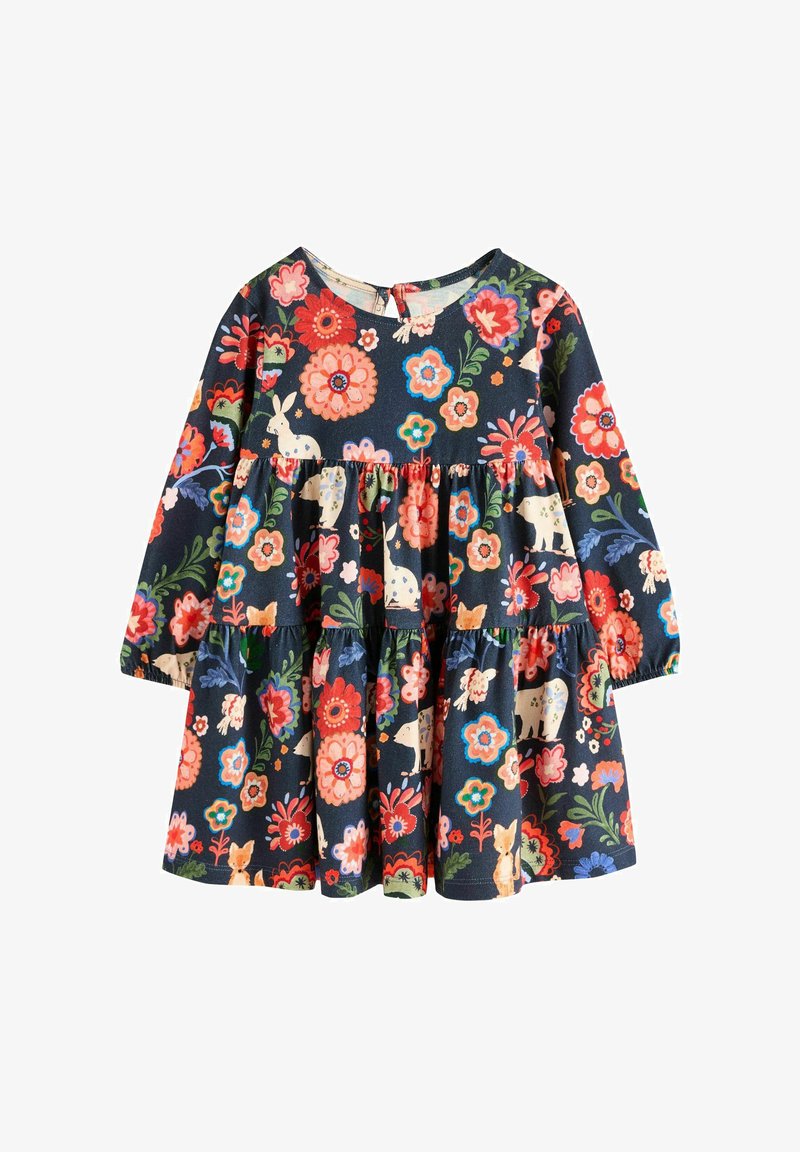 Robe à manches longues en tissu bleu marine avec un motif floral comportant des fleurs rouges, roses, bleues et des imprimés animaliers. Design superposé avec un col rond.
