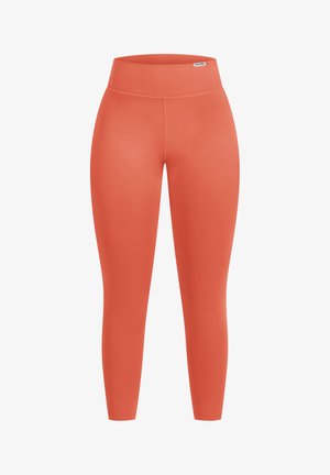 Orange leggings with a high waistband, smooth texture, and fitted shape. Features a seamless design and a small logo tag near the waistband.