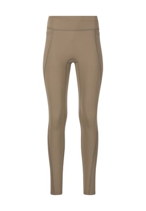 Leggings beiges taille haute avec coutures visibles et un design lisse et ajusté allant jusqu'aux chevilles.