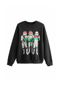 Felpa nera con tre stormtrooper che indossano cappelli di Babbo Natale e sciarpe, mentre tengono in mano libretti di canzoni verdi. Realizzata in miscela di cotone con scollatura a coste.