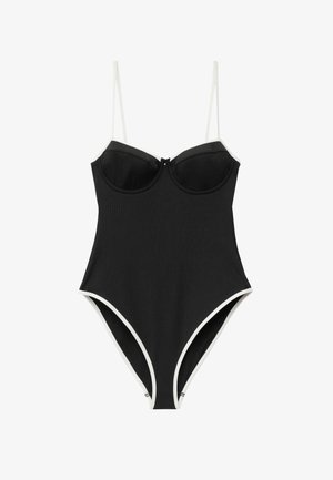 Black one-piece swimsuit with white trim, built-in underwire cups, and thin adjustable shoulder straps.