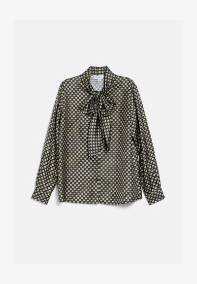 Blouse noire à manches longues avec un petit motif géométrique jaune et un nœud noué au col, boutonnée devant, manches à poignets.