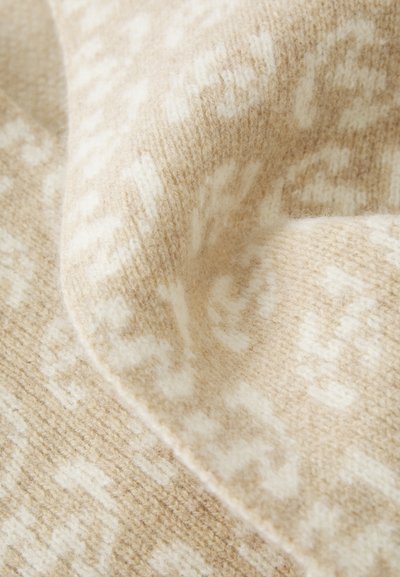 Beige mønstret uldstof med en blød tekstur, der har subtile hvide designelementer. Materialet fremstår varmt og hyggeligt.