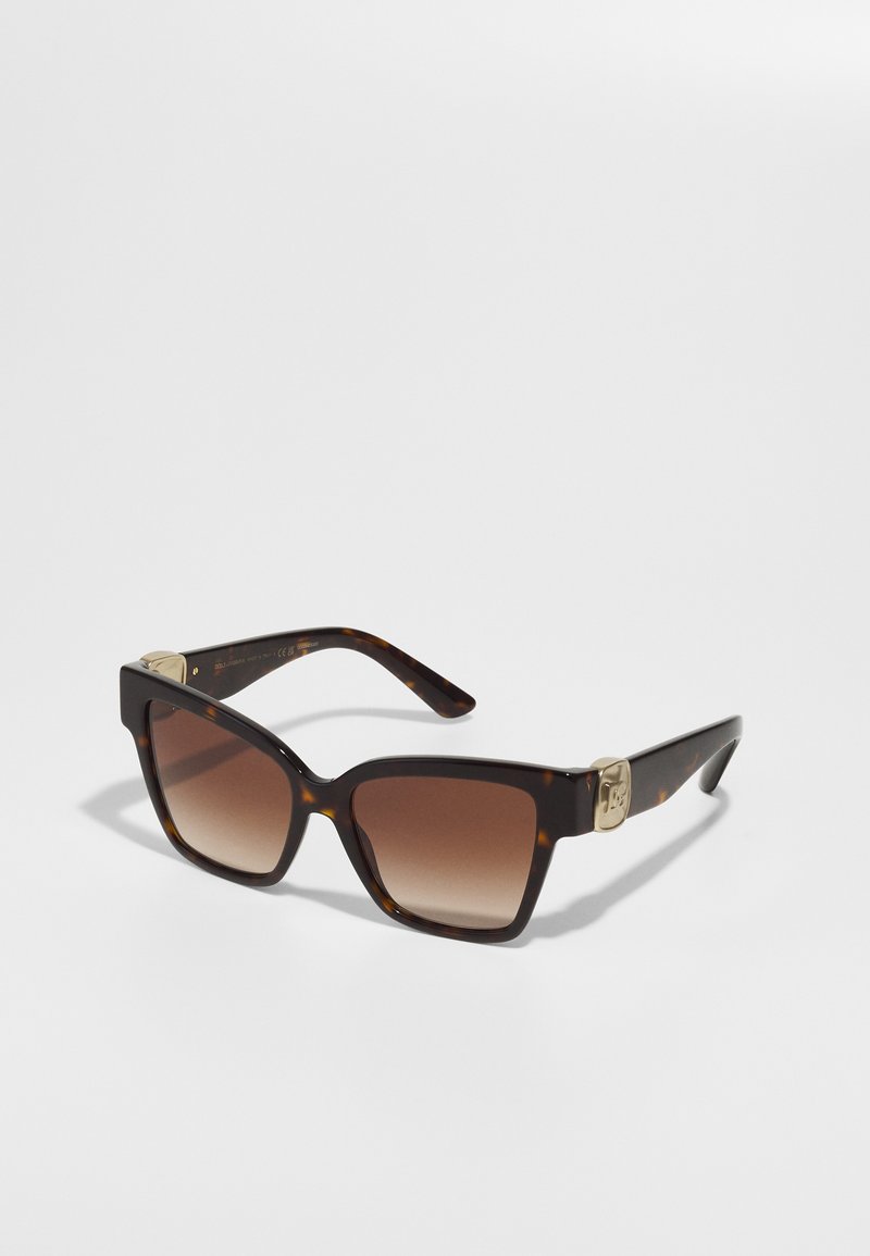 Sunglasses with a tortoiseshell frame, square shape, gradient brown lenses, gold hardware accents on temples, and a smooth finish.