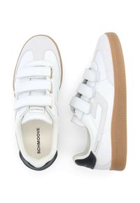 Baskets blanches en cuir et en daim, dotées de trois bandes velcro, d'une semelle en caoutchouc brun clair et d'accents noirs au talon.