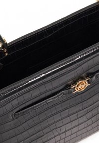 Black crocodile-embossed leather bag with a gold-tone hardware clasp and a smooth, interior lining. Features a slip pocket and structured design.