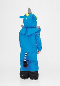 Blå snödräkt med huva som har grå och gula accenter, spetsiga designelement och en svart och vit randig svans bak.