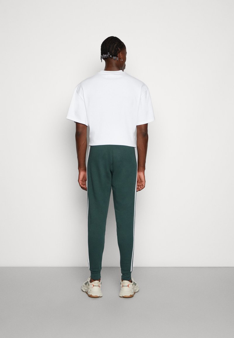green adidas joggers men