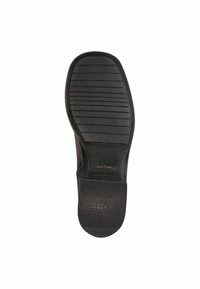 Suela de zapato de goma negra con agarre texturizado y entalladuras horizontales, que presenta un tacón plano y el nombre de la marca grabado "ANTI SLIDE."