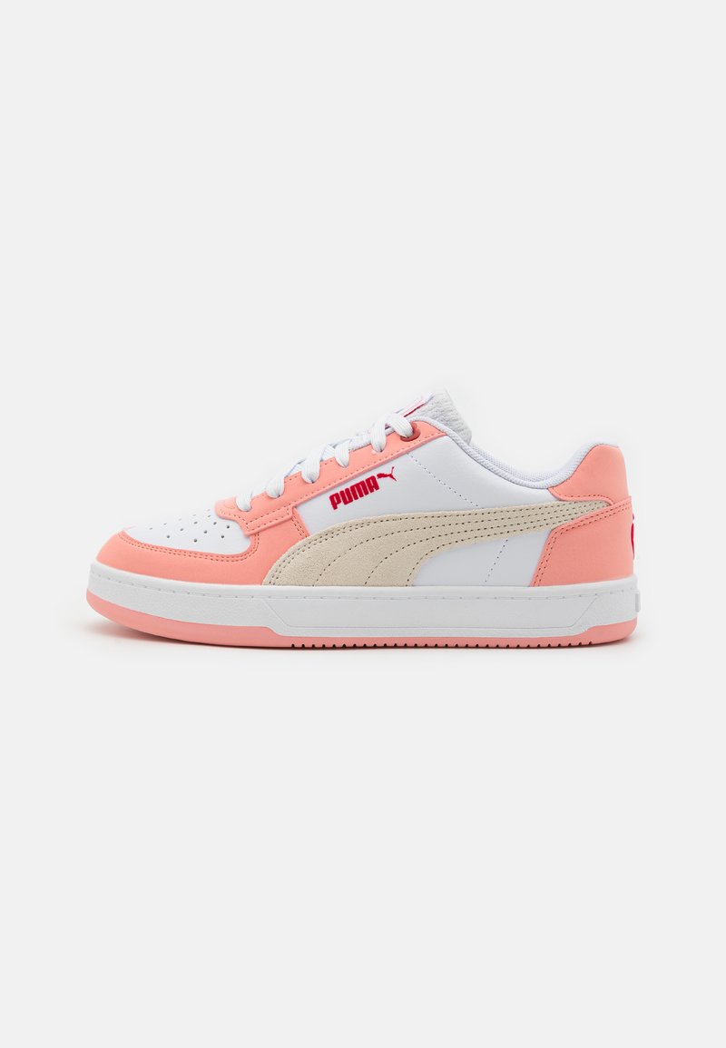 White and peach low-top sneakers with suede and mesh accents, featuring a textured sole, perforated toe box, and red Puma logo.