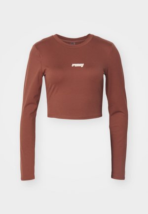 Brun langermet crop topp laget av et stretchy materiale, med en hvit "ruby" logo på fronten. Jevn tekstur og tettsittende design.