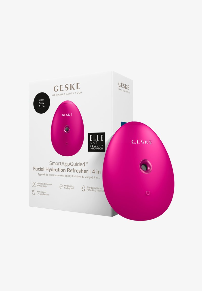 Un appareil portable rose vif en forme d'œuf, avec un devant arrondi et un petit bouton. Livré avec une boîte blanche portant du texte et des logos.