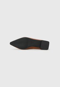Brown leather high-heeled shoe with a pointed toe, featuring a black rubber sole and a square heel. Textured bottom for grip.