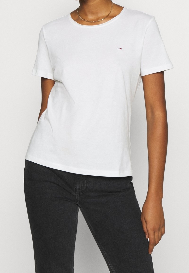 White cotton T-shirt with a classic crew neckline and short sleeves. Features a small logo on the chest and a relaxed fit.