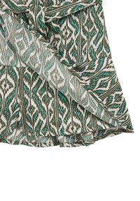 Wrap dress featuring a green and turquoise ikat pattern on a white background, with a tied waist detail and soft, flowing fabric.