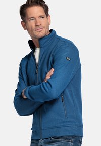 Blauwe zip-up jas voor heren van textuurstof, met een hoge kraag, zijzakken met rits en een logodetail op de mouw.