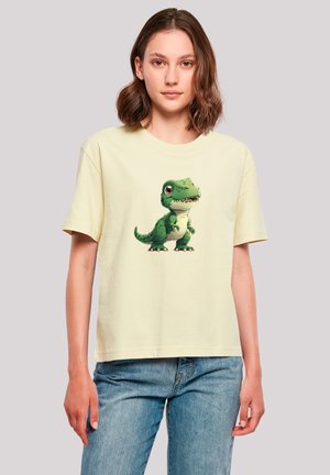 Yellow cotton t-shirt featuring a green cartoon dinosaur graphic on the front. Relaxed fit, short sleeves, and crew neck design.