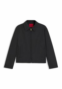 Black cropped jacket with a pointed collar, front zipper, and side pockets. Features a red "HUGO" label inside the collar.