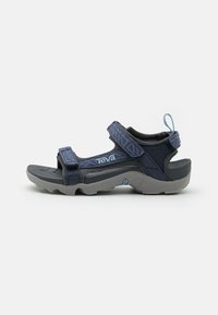 Navy blue sandal with adjustable straps, grey rubber sole, textured upper, and rear pull tab. Features Teva logo on the side.