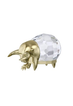 Gold-toned bull figurine with intricate details, clear faceted crystal body, and a floral accent, resting on four small legs.