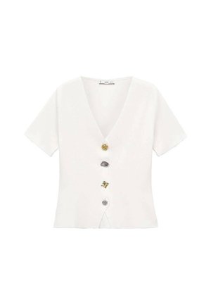 Witte top met korte mouwen en V-hals, voorzien van vijf decoratieve knopen in goud, zilver, grijs en met patronen in het midden.