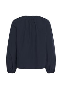 Blouse bleu marine avec de longues manches bouffantes, un col froncé et une coupe ample. Fabriquée en tissu léger au toucher doux.