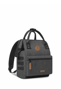 Gray fabric backpack with leather accents, top handles, and adjustable straps. Features a front zip pocket and a circular logo patch.