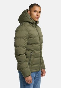 Padded olive green jacket with a hood, featuring a zip and snap button closure, side pockets, and horizontal stitching details.
