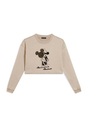 Sweatshirt court beige en tissu doux, avec un graphique noir représentant un personnage tenant une fleur, complété par le texte "Minnie Mouse" en dessous.