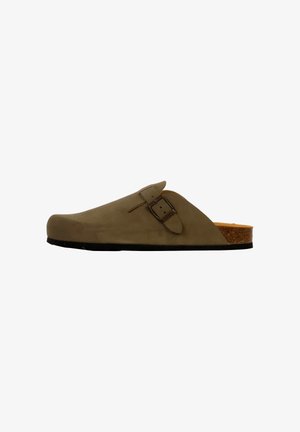 Beige suede clog with a smooth surface, adjustable buckle detail, and a cork footbed, featuring a black rubber sole for traction.