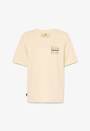 T-shirt à manches courtes, de couleur crème, en coton, avec un imprimé du logo Timberland en noir sur la poitrine et une étiquette sur le côté.
