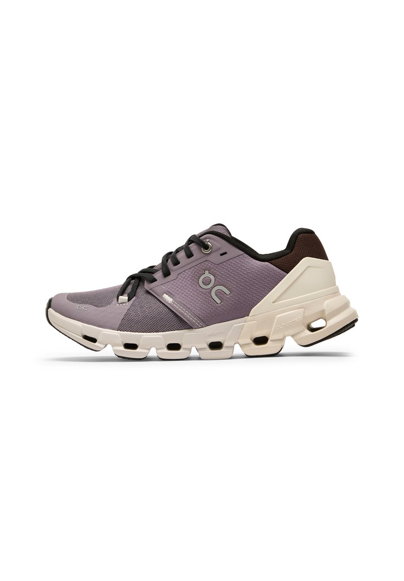 Purple athletic shoe with a mesh upper, black accents, and a chunky white sole featuring cutout sections for cushioning.