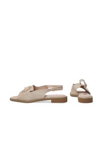 Beige slingback boty s texturovaným povrchem, zdobené perlou a řetízkovým akcentem, a s nízkou hnědou podrážkou.