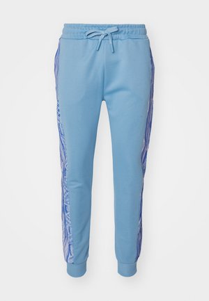 Light blue sweatpants with a drawstring waist, featuring patterned side panels in darker blue tones and ribbed cuffs at the ankles.