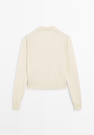 Cream-colored knitted sweater with a polo collar, long sleeves, and a cropped design. Soft texture and ribbed cuffs and hem.