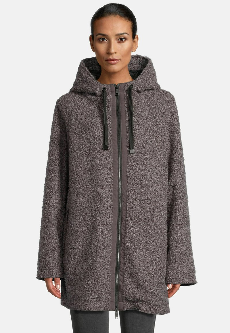 Oversized hooded coat in soft, textured gray fabric with a front zipper, contrast trim, and large pockets on each side.
