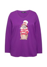 Lila Langarm-T-Shirt mit V-Ausschnitt, das ein Grafikum eines Nagetiers in einem rot-weiß gestreiften Pullover und Hut zeigt.