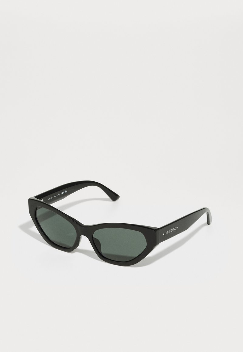Black, angular sunglasses with green lenses and textured frame. Features slim arms and subtle branding on one side.