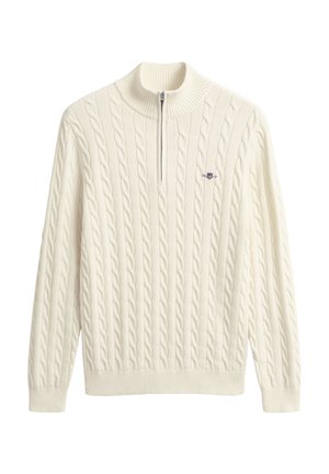 Roomkleurige kabelgebreide trui met een halve ritskraag en geribde zoom en manchetten. Heeft een klein logo op de borst.