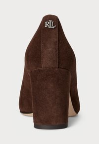 Brown suede high-heeled shoe with a tapered design, featuring a silver "RL" logo accent at the back and a sturdy block heel.