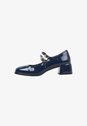 Chaussure Mary Jane en cuir verni marine avec un bout arrondi, deux brides décoratives à boucle et un talon cubique. Texture de surface lisse.