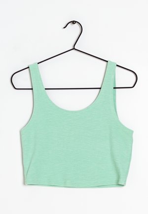 Mint green textured fabric crop top with wide shoulder straps hanging on a black wire hanger against a white background.