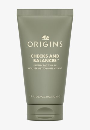 Groene knijptubeverpakking met een beige label. Tekst bevat "Origins" en "Checks and Balances Frothy Face Wash." Inhoud 50 ml.