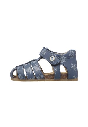 Blue toddler sandal with turtle prints, closed heel, open toe straps, and adjustable Velcro strap with a circular "F" button.