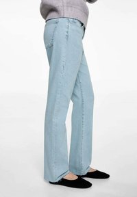 Svetlomodré, vysoko pásové džínsy s rovnými nohavicami, s minimálnym prešitím, rozstrapkanými okrajmi a klasickým dizajnom s piatimi vreckami.