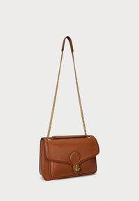 Brown leather handbag with a magnetic flap closure, gold chain strap, and embossed "RL" logo on the front. Smooth texture, rectangular shape.