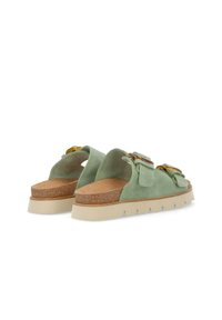Green suede sandals with a cork footbed, adjustable straps, and a chunky beige sole featuring a textured pattern.