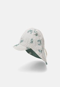 Cotton bucket hat in light beige with green crab pattern. Features a wide brim, adjustable chin strap, and contrasting green lining.