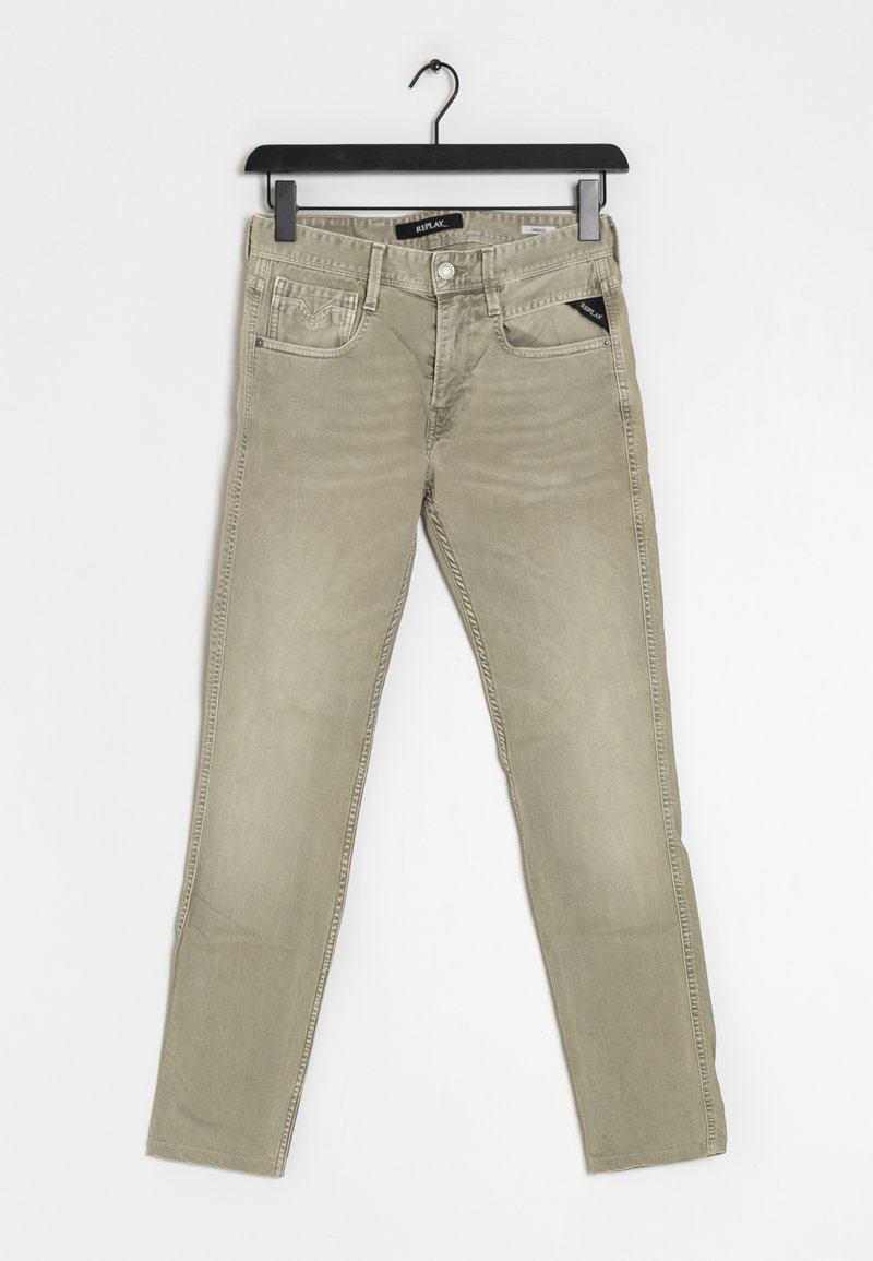 Jean slim beige avec poches avant et poche monnaie, passants de ceinture, fermeture par bouton, suspendu à un cintre en plastique noir sur fond blanc.